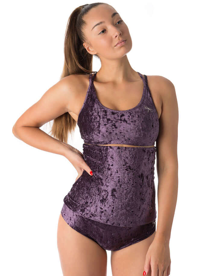 Model wearing velvet booty shorts and tank top in purple, showcasing a stylish and comfortable fit for pole dancing.