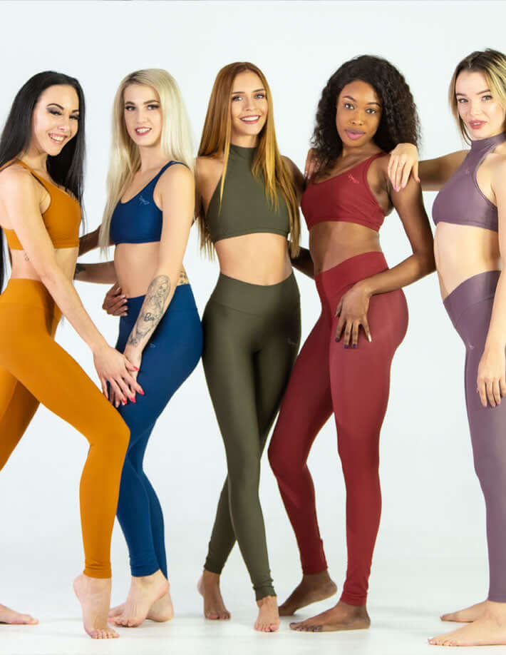 Group of diverse models showcasing mid rise leggings in various colors and styles, perfect for yoga and comfortable wear.